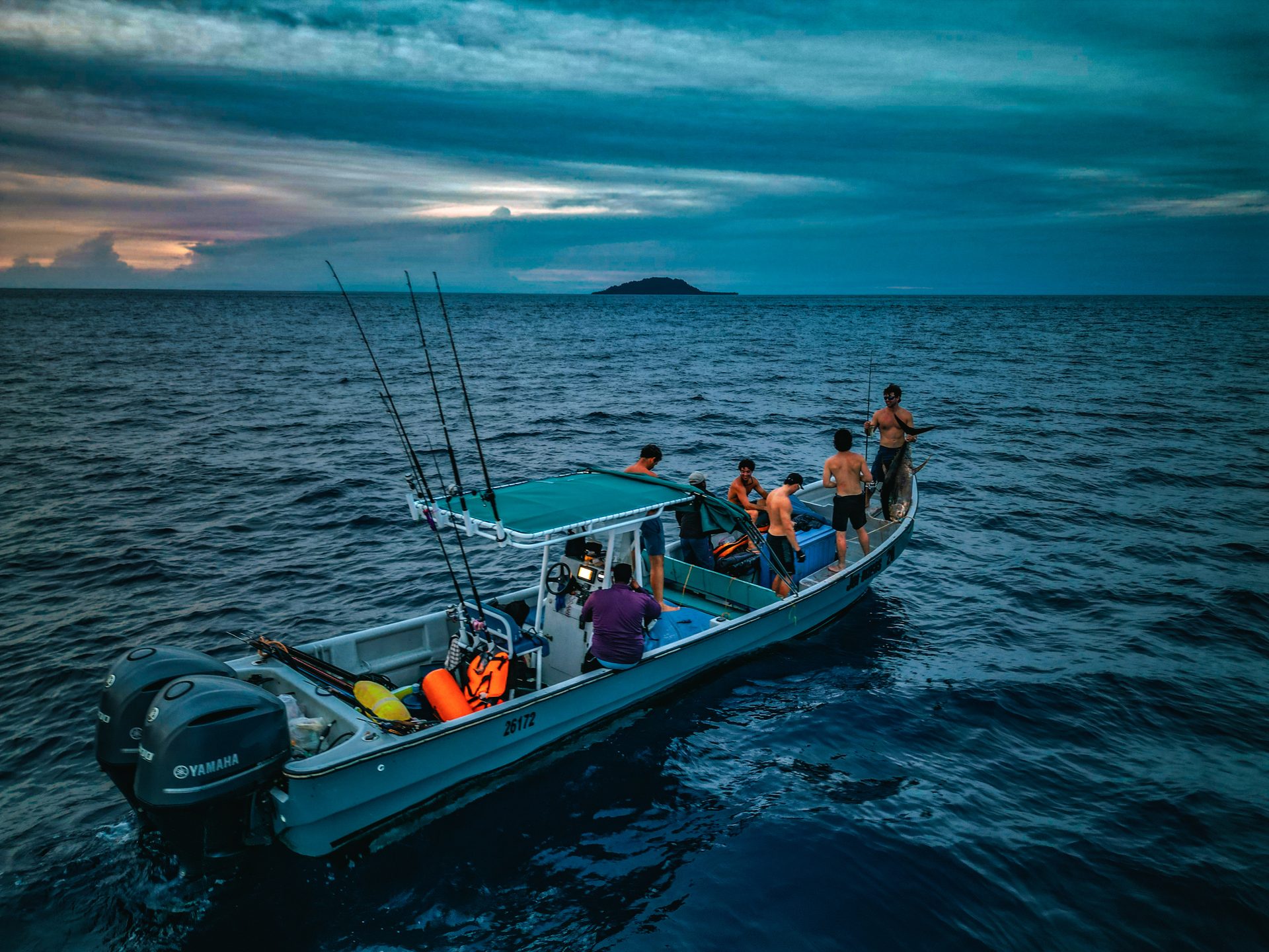 Spearbaby fishing boat at dawn offshore Panama with island in background